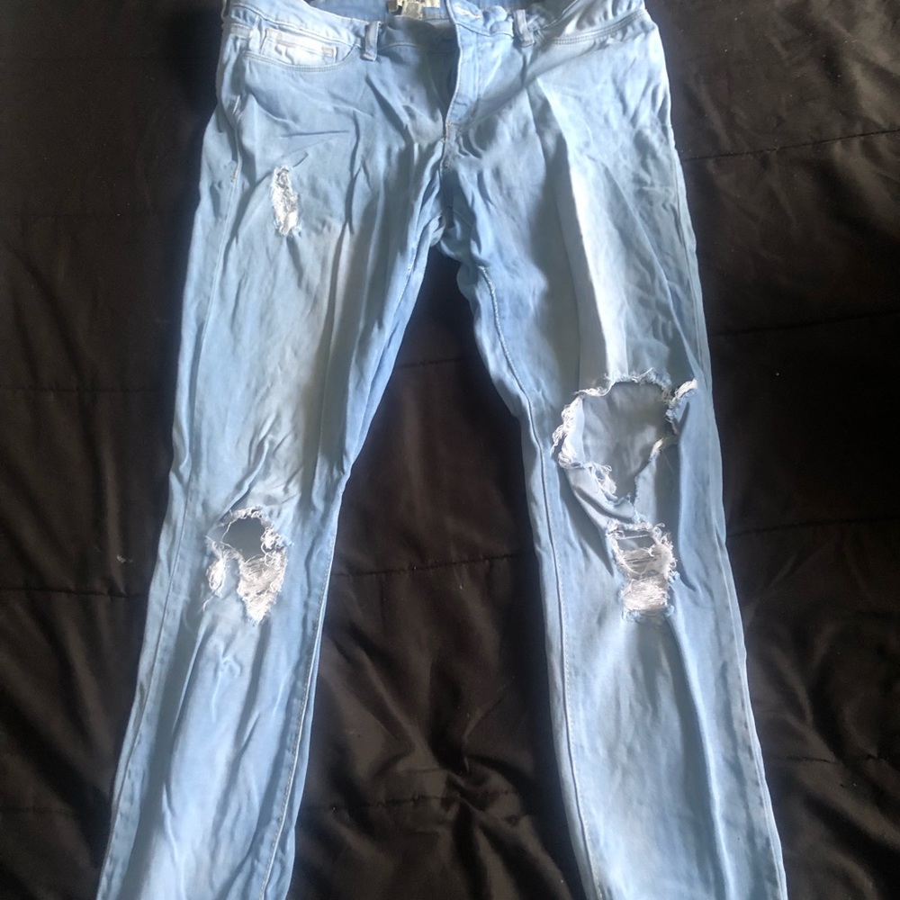 Ripped/ holey light blue jeans
